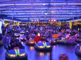 Teenagers Ride Bumper Cars under Neon Blue Lights Photographic Print by Dominic Bonuccelli