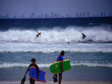 Surfers with Surfers Paradise in Distance Photographic Print by John Borthwick