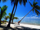 Woman Sunbathing on a Palm Tree on a Tropical Beach in Malaysia Photographic Print by Tim Rock
