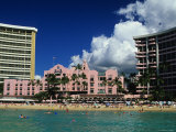 Exterior of the Royal Hawaiian Hotel with Waikiki Beach in Foreground Photographic Print by Ann Cecil
