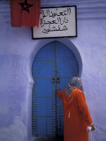 Woman Exits thru Moorish-Style Blue Door, Morocco Photographie par John & Lisa Merrill