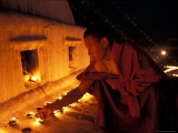 Monk Lighting Butter Lamps at Boudnath, Kathmandu, Nepal Photographic Print by Vassi Koutsaftis