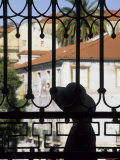 Tourist Gazes at Historic House through Iron Grillwork of Church, Lisbon, Portugal Photographic Print by John & Lisa Merrill