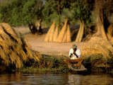 Local Man Fishing and Piles of Straw for Hatch, Okavango Delta, Botswana Photographic Print by Pete Oxford