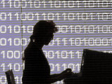 Silhouette of Woman Working on Computer Photographic Print by Bill Bachmann