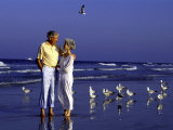 Retired Couple Relaxing on the Beach Photographic Print by Bill Bachmann