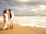 Hispanic Couple Walking Together on the Beach Photographic Print by Bill Bachmann