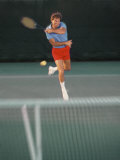 Man Hitting Tennis Ball Photographic Print by Bill Bachmann
