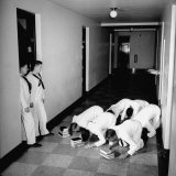 US Coast Guard Academy, Lower Classmen Bowing over Books, Hoping for Luck in Examinations Premium Photographic Print by William C. Shrout