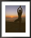 A woman doing yoga at sunrise on the East Cape of Baja, Mexico Posters by Jimmy Chin