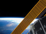Solar Array Panels on the International Space Station Backdropped Against Earth's Horizon Photographic Print by Stocktrek Images 