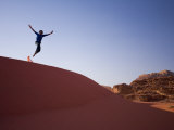 Person Jumping Off Sand Dune, Wadi Rum Desert, Jordan Photographic Print by Michele Falzone