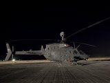 OH-58D Kiowa Sits on its Pad at Night Photographic Print by Stocktrek Images 