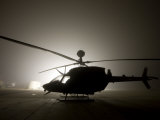 Stocktrek Images - Illumination from the Bright Light Silhouettes of OH-58D Kiowa Helicopter During Thick Fog Fotografická reprodukce Stocktrek Images - Illumination from the Bright Light Silhouettes of OH-58D Kiowa Helicopter During Thick Fog Fotografická reprodukce