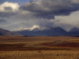 Scenic View of Snow-Capped Mountains, Clouds, and Grasslands Photographic Print by Marcia Kebbon