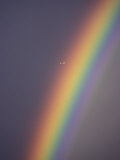 Rainbow and Airplane in a Clear Sky, West Canada Photographie par Paul Nicklen