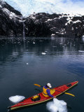 Woman Sea Kayaking Past an Ice Floe, Prince William Sound, Gulf of Alaska Photographic Print by Kate Thompson