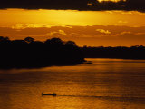 Water Taxi Ferries People across the Madre De Dios River at Sunrise Photographie par Maria Stenzel