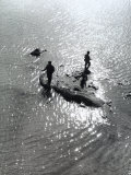 Two Fishermen Fishing on a Finger of Land That Emerges Out of the Water Photographic Print by Vincenzo Balocchi