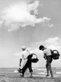 Two Young Travelling Salesmen Walking on a Beach Photographic Print by A. Villani