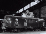 Locomotive under Construction in a Shed where Technician is Busy Installing the Motor Photographic Print by A. Villani