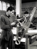 Technician Grinding a Piece of Metal Inside a Caproni Hangar Photographic Print by A. Villani