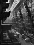 Off-Loaded Freight From Box Cars Being Hoisted Up to Jutting Loading Platforms at Brooklyn Army Bas Lámina fotográfica por Andreas Feininger