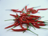 Red Hot Chillies on a White Sheet Photographic Print by Charcrit Boonsom