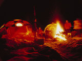 A climbing team celebrates Christmas Eve with a bonfire at base camp Photographic Print by Tommy Heinrich