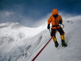 A mountain climber battles icy blasts of wind on Nanga Parbat Photographic Print by Tommy Heinrich