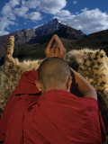 A monk prays for an end to snow leopard killings Photographic Print by Steve Winter
