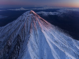 Kronotsky Volcano towers above nearby peaks, tundra, and forest Photographic Print by Michael Melford