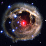 Radiation from a stellar burst ricochets off dust particles Photographie par Esa And Nasa