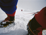 Climbers ascend a steep slope of Nanga Parbat in stormy conditions Photographic Print by Tommy Heinrich