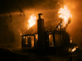 Flames engulf a house during a forest fire Photographic Print by Mark Thiessen