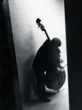 Young Bassist Member of Alexander Schneider's New York String Orchestra Tuning His Instrument Stampa fotografica di Gjon Mili