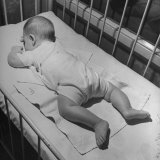Baby Sleeping on its Stomach in Nursery at St. Vincent's Hospital Photographic Print by Nina Leen