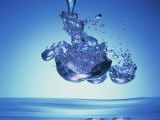 Iridescent Water Bubble Formation Floating Above the Surface of Deep Blue Water Impressão fotográfica