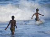Two Boys Playing in the Surf on the Beach, Manakara Town, East Coast of Madagascar Poster von Inaki Relanzon