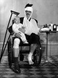 Heavily Bandaged English Man Sitting in Wheelchair with a Child, an Advertisment for a Health Plan Lámina fotográfica