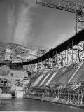 The Grand Coulee Dam under Construction with a Sign in the Bkgrd. That Says: The Grand Coulee Dam under Construction with a Sign in the Bkgrd. That Says: