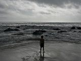 Child Standing at the Edge of Tide Posters by Krzysztof Rost