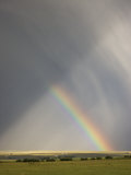 A Rainbow Moves across Hermit Basin Near Westcliffe, Colorado in a Rainstorm Photographic Print by Don Grall