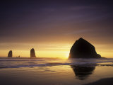 Haystack Rock and Other Sea Stacks Silhouetted at Sunset, Cannon Beach, Oregon, USA Photographic Print by Adam Jones