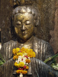 Statue with Offering of Marigold Flowers, Emerald Buddha Temple, Bangkok, Thailand, Southeast Asia Photographic Print by Alain Evrard