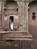 Priest Stands at the Entrance to the Rock-Hewn Church of Bet Gabriel-Rufael, Lalibela, Ethiopia Photographic Print by Mcconnell Andrew