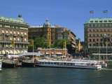 Sightseeing Boat and Waterfront Hotels and Cafes in the City Centre, Stockholm, Sweden, Scandinavia Photographic Print by Maxwell Duncan
