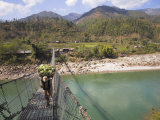 Man Carrying Vegetables across a Rope Bridge, Bandare Village, Trisuli Valley, Nepal Photographic Print by Jane Sweeney