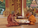 Group of Buddhist Monks in Saffron Robes Sitting on the Floor, Wat Chan in Vientiane, Laos Photographic Print by Taylor Liba