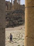 View Through Columns of Boy Walking Past, Jerash, Jordan, Middle East Photographic Print by Simanor Eitan
